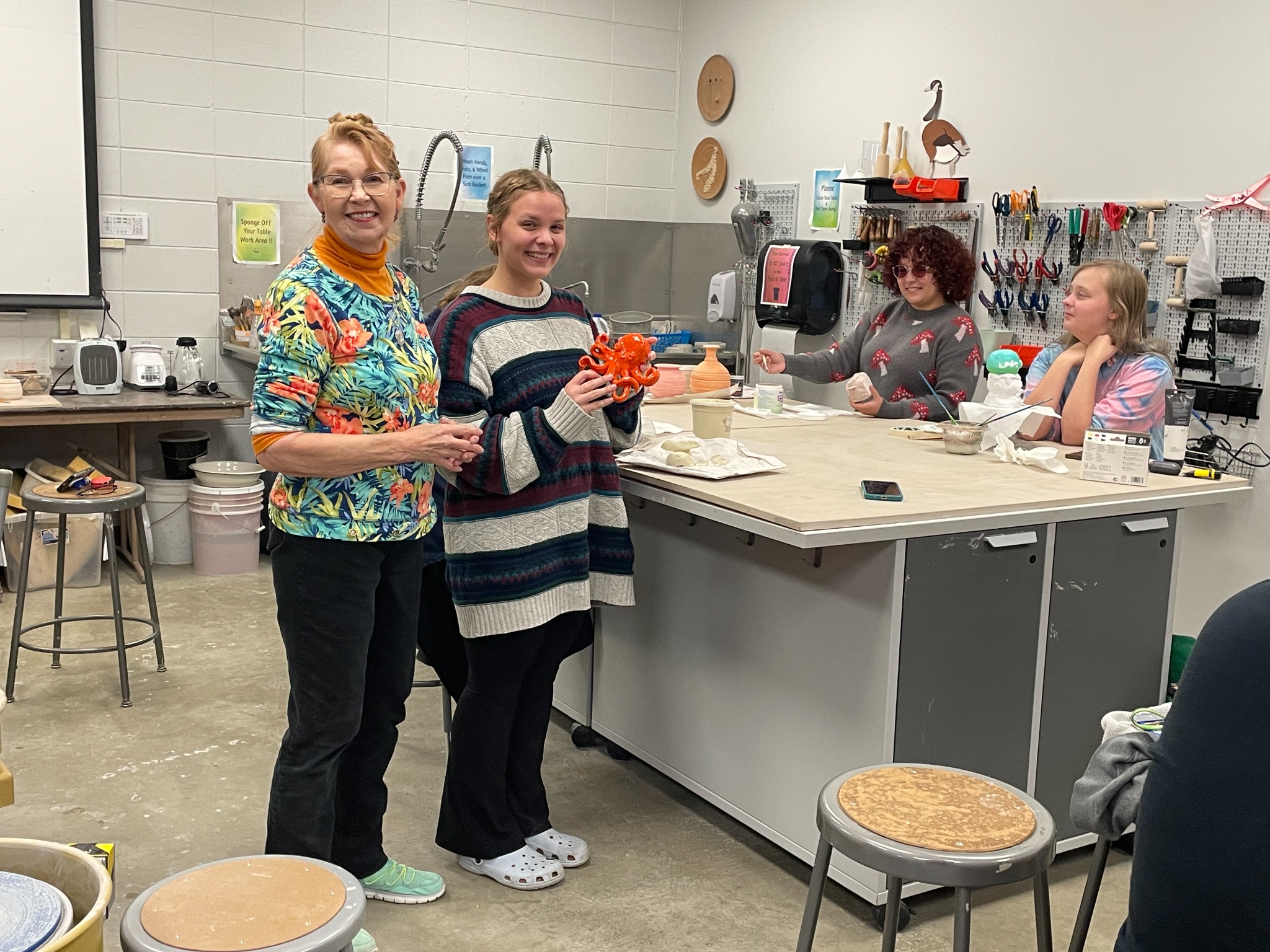 Martie Geiger-Ho with ceramics students at NIACC.