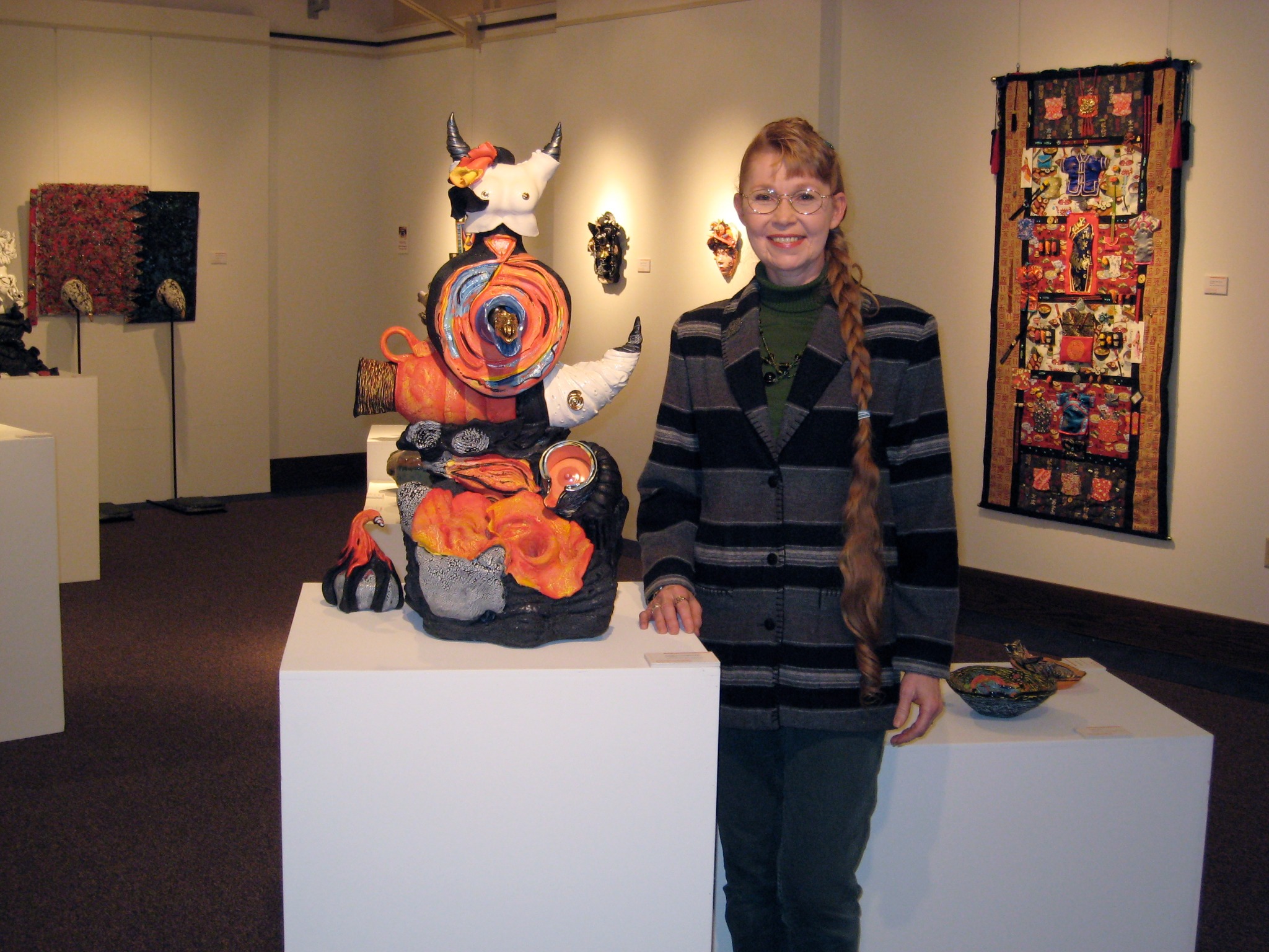 Martie Geiger-Ho with a Kiln Goddess sculpture in the exhibition
