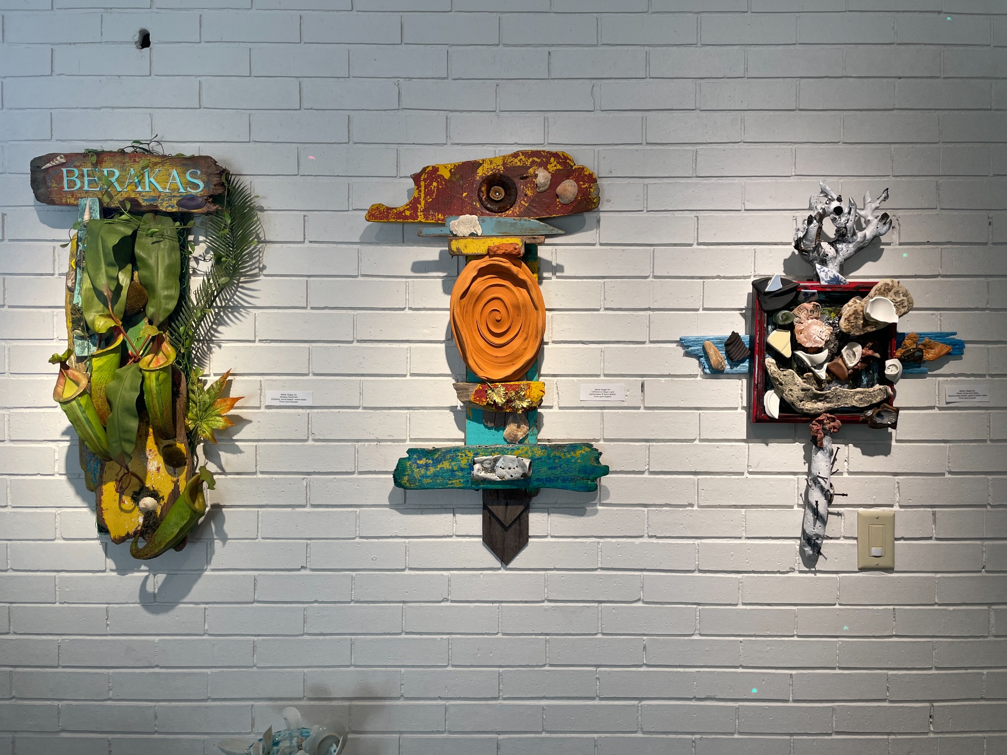 Detail installation view of mixed-media works.