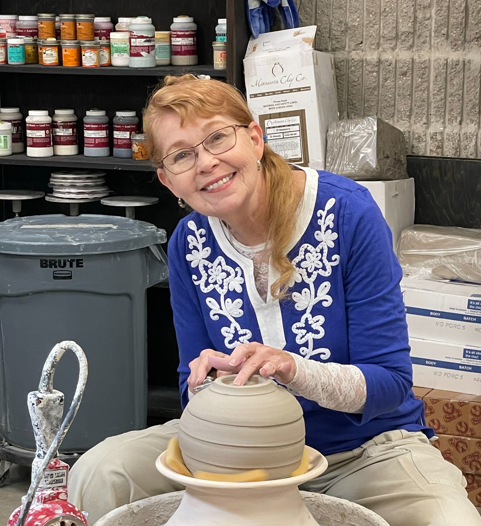 Martie Geiger-Ho working on a ceramic vessel in the studio.