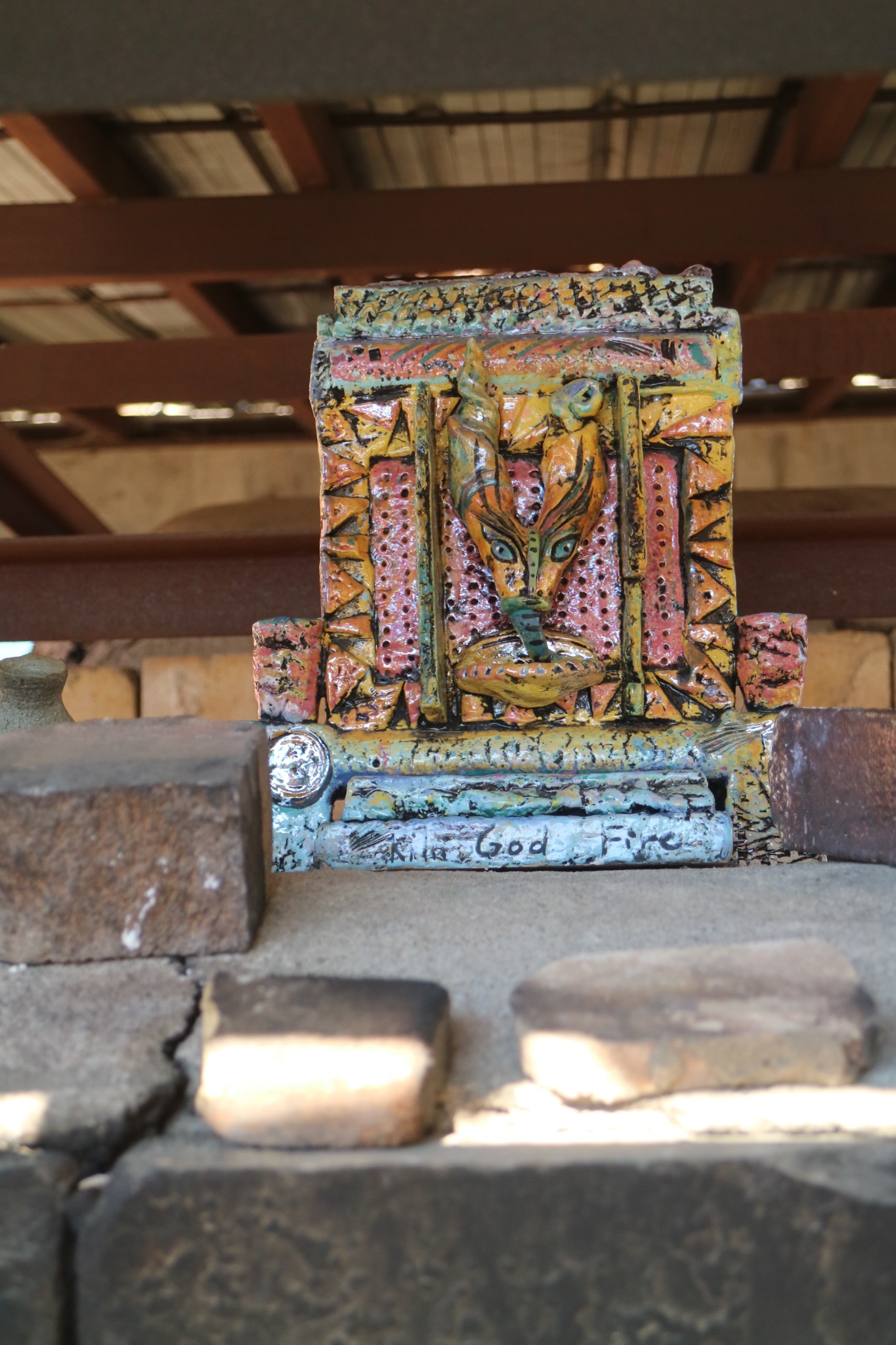 Martie's ceramic kiln god placed on the Medalta kiln.